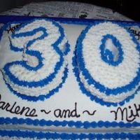 30Th Birthday 1/2 sheet with 30 cut out of oval pans covered in buttercream.