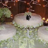 Ivory Wedding Cake This was a scramble to fix up! The icing was melting... the tiers collapsing.. There 'were' four tiers. When I started assembling...