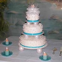 Pearls And Daisies Wedding Cake I used BC with the faux fondant technique. Pan sizes are 14", 10", 6". The pearls and flowers are made from fondant.