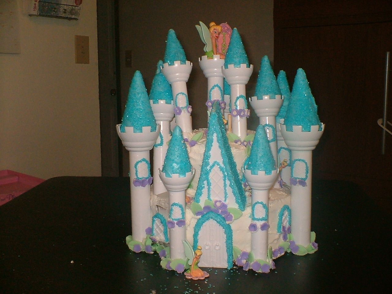 Castle Birthday Cake This was my daughters birthday cake. Used buttercream to cover and added fondant flowers and leaves the piller tops were done with candy...