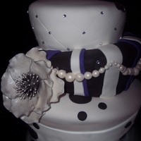 Amanda's 21St a lastminute cake for my sister: Topsy-turvy 10" - 8" - 6" covered in fondant with gumpaste Anemone and rhinestone accents....