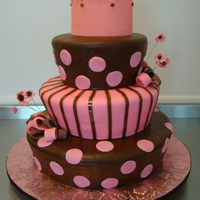 Karla's First Birthday Tapered 3 tier cake covered with MMF in pink and chocolate brown. Crown made from gumpaste, flowers and bows from MMF