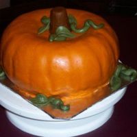 Pumpkin Cake Pumpkin shaped made with 2 bund pans and covered with MMF. The cake flavor was pumpkin spice with cinnimon buttercream icing.