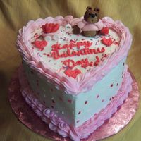 Hearts For My Valentine .... Heart shape yellow cake with BC icing. Sculpted bear, wagon and hearts from fondant. Royal icing lettering.