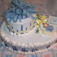 Baby Shower - With Hand Sculpted Baby Fondant bow, edible beads, fondant drop flowers, royal day lilies, edible image, hand sculpted baby with blanket and his little bum showing...