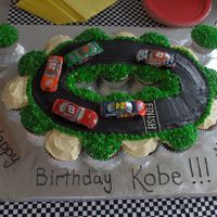 Nascar Birthday Cupcakes My son insisted on having his cake loaded with cars. I used cupcakes smothered in icing to create the track.