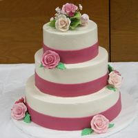 Pink And Fuschia Wedding Cake Swiss buttercream with fondant ribbons and gumpaste roses.
