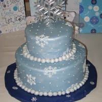 Snowflake Cake Vanilla cake with ganache filing. Covered in fondant with royal icing snowflakes.