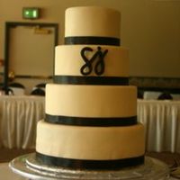 Wedding Cake Cake is covered with ivory fondant with the SJ symbol made out of gum paste.