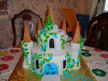 Castle Cake 10" and 6" with ice cream cones for the towers. Covered in BC. I used a impression mat to make the building itself look like...