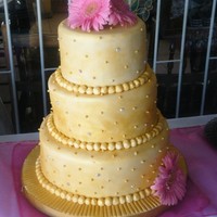 3Tier Gold Wedding Cake 10, 8 & 6" chocolate cake with white chocolate frosting (filling). Gold dusted and real swarovski crystals stuck on the cake. I...