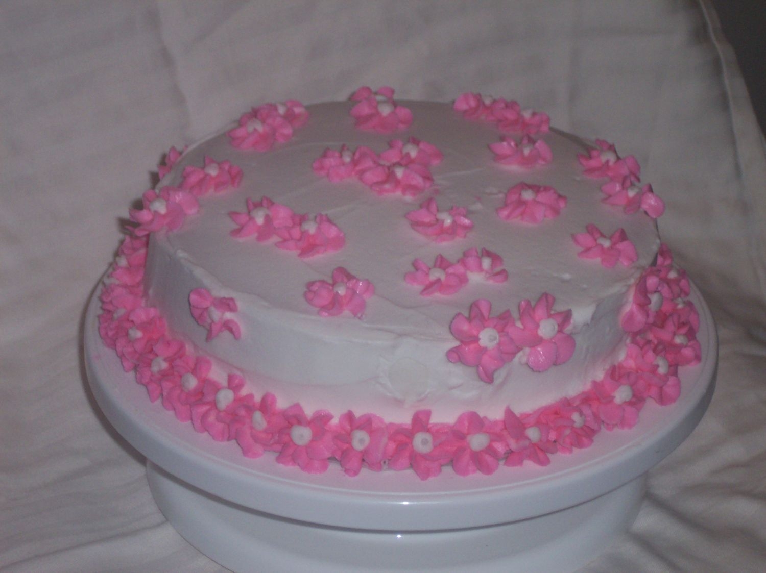 Drop Flower Cake yellow cake with white icing. Pink drop flowers. Wilton 1 cake decorating class project