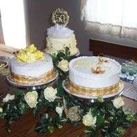 50Th Anniversary Cake First Time made for husbands Aunt and Uncle for there 50th anniversary. top layer is white, middle is red velvet, and bottom layer is fudge marble....