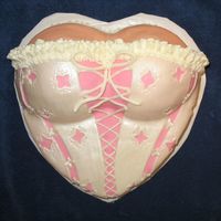 Corset Cake This was inspired by a corset cake done by "bpsrj". Its a 10" heart pan with ball pan halfs covered in MMF. This was a lot...