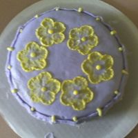 Sams_Second_Cake_2.jpg purple and yellow buttercream. brush embroidery flowers and basket weaving along sides.