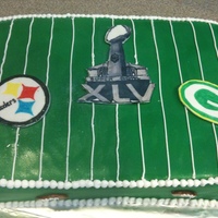 2011 Super Bowl Cake This is a cake I made for a Super Bowl party I was going to. The fondant logos were painted.