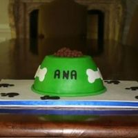 Dog Bowl And Place Mat This was for a little girl who loves dogs. Two 8" cakes carved, iced and covered in mmf. The "kibbles" are Coco Puffs.