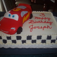 Lighting Mcqueen I used the 3-d car cake pan w/marshmellow fondant for the car and piped stars for the checker board pattern on the sides.
