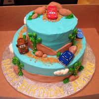 002Cars.jpg Cars Cake, Chocolate inside both tiers, BC and fondant accents, plastic cars