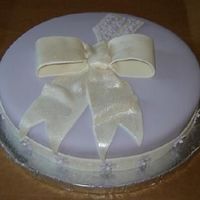 Miriam 10 inch cake covered in fondant with fondant ribbon/bow/tag/flowers