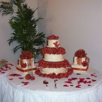 Toya Wedding 3 Tier round with roses and 2 gift shaped satellites. When I arrived at the reception location, I realized that the top tier had been left...
