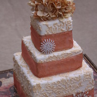 Favorite For Fall 2009 Square cake with stenciled and piped design with non-edible ribbon, flowers, and pendants.