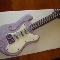 Hannah Montana Guitar Cake "Marbled" Fondant covering with fondant/Tylose accents and strings. Strings extruded thru a clay press. It worked...but still...