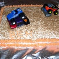 Monster Truck I made this cake for my husbands bday. I bought two monster trucks and put down some cinamon for dirt. I made my own checkered flags and...