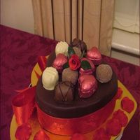 My First Valentine Cake Made this for my other half, it's chocolate cake, covered with chocolate paste, the chocs are shop bought belgian, the miniature rose...