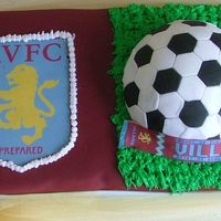Football (Soccer) Cake For Hubby 8" x 16" x 3" Chocolate cake covered with Burgundy / claret fondant...Team colours used.... Had to use tulle bow to cover...