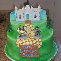 Shrek Themed Cake Frosted in B/C With fondant walk-way, river, bridge, flowers and Birthday sign. Deco Pac Shrek decorations. Cake was airbrushed. For a 2...