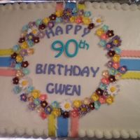 90Th Birthday Buttercream covered cake with fondant ribbons and gumpaste flowers.