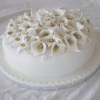 Calla Lilies This was one of two fondant covered cakes for a garden wedding. The calla liles were made from a mixture of fondant and gum trag. It's...