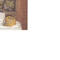 Helmets The groom is a LSU fan ,I made 2 helmets out of chocolate cake covered with fondant. The face guard is made of pastillage.