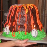 Volcano Cake This was for my husband's 40th birthday. It is a chocolate cake with chocolate frosting. The top layer is a bundt cake with a votive...