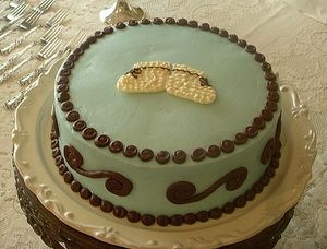 Baby Blue Bootie White cake all buttercream with white chocolate booties on top.