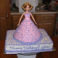 Swirly Barbie Doll cake on a 1/4 sheet base. I usually have a hard time designing dresses in buttercream for doll cakes...but was pleased with all the...