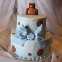 Baby Bear 6" stacked on 9", buttercream w/fondant accents & teddy bear, gumpaste bow. The gal doing the shower wanted blue & brown...