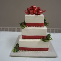 Christmas Wedding 6-8-10 Square tiers, buttercream frosting, gumpaste holly & bow (from Diane's Cakes & More), satin ribbon. Base is a 16"...