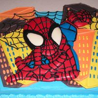 Spiderman I made this for a boy who was turning 4 years old. Spiderman and Building made from chocolate. Laid on top of cake with buttercream icing...