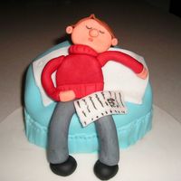 Guy Sleeping On Couch Cake covered in fondant. Molded guy out of fondant. Cake inspired by a book that I have.