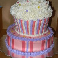 Cupcake all buttercream with fondant cherry and sprinkles. used half the ball pan for the top of the cupcake