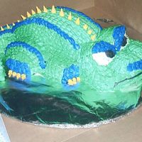 Dragon Cake Fun dragon cake. Carved dragon out of two round pans. Buttercream icing. Used one of the rose tips for the scales.