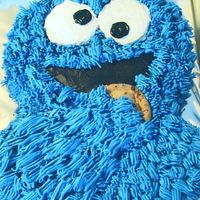 Cookie Monster Cookie Monster cake for a first birthday girl. Chocolate Cake with buttercream frosting and a real choc. chip cookie.