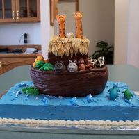 Noah's Ark Cake This was a birthday cake we did for a first birthday. The figures are all made from MMF, the house on the boat is made from chocolate...