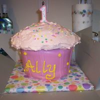 Large Cup Cake Choc mud cake with chocolate filling bottom half covered with Fond, Top covered with buttercream. Made to match the invitations.