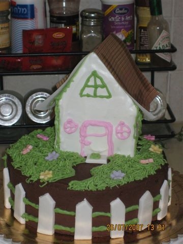 New Home Chocolate cake w/buttercream icing and accents. House was made of royal icing, decorated with buttercream. The picket fence is home-made...