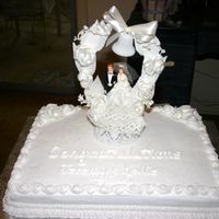 Congratulations Jeremy & Kellie Small single layer wedding cake for a private in home wedding. Everything is white buttercream with champagne flavoring. The topper on the...