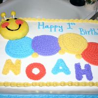 Happy 1St Birthday Noah Baby Einstein caterpillar was requested. The head is a small cake covered in fondant. The body is just buttercream icing.