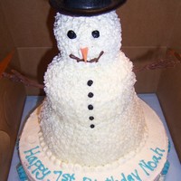 Snowman This was for a child's first birthday. Chocolate cake with bc icing. The blue writing and snowflakes are melted candy wafers. TFL.
